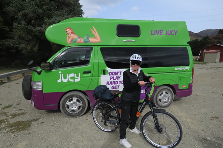 Girl on bike outside JUCY campervan Girl on bike outside JUCY campervan